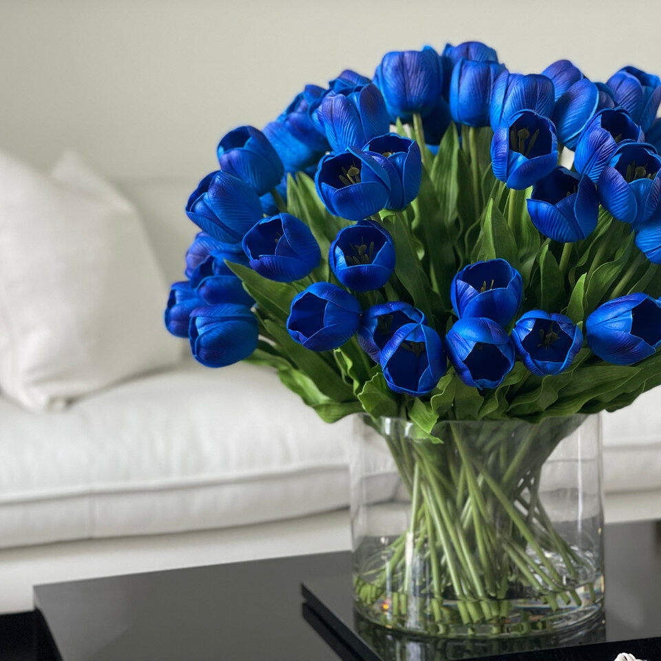 Arrangement of blue tulips in a large cylindrical vase – The Ever Botanic